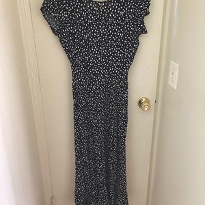 Navy w/ white polka dots. Open back. Slit on leg.